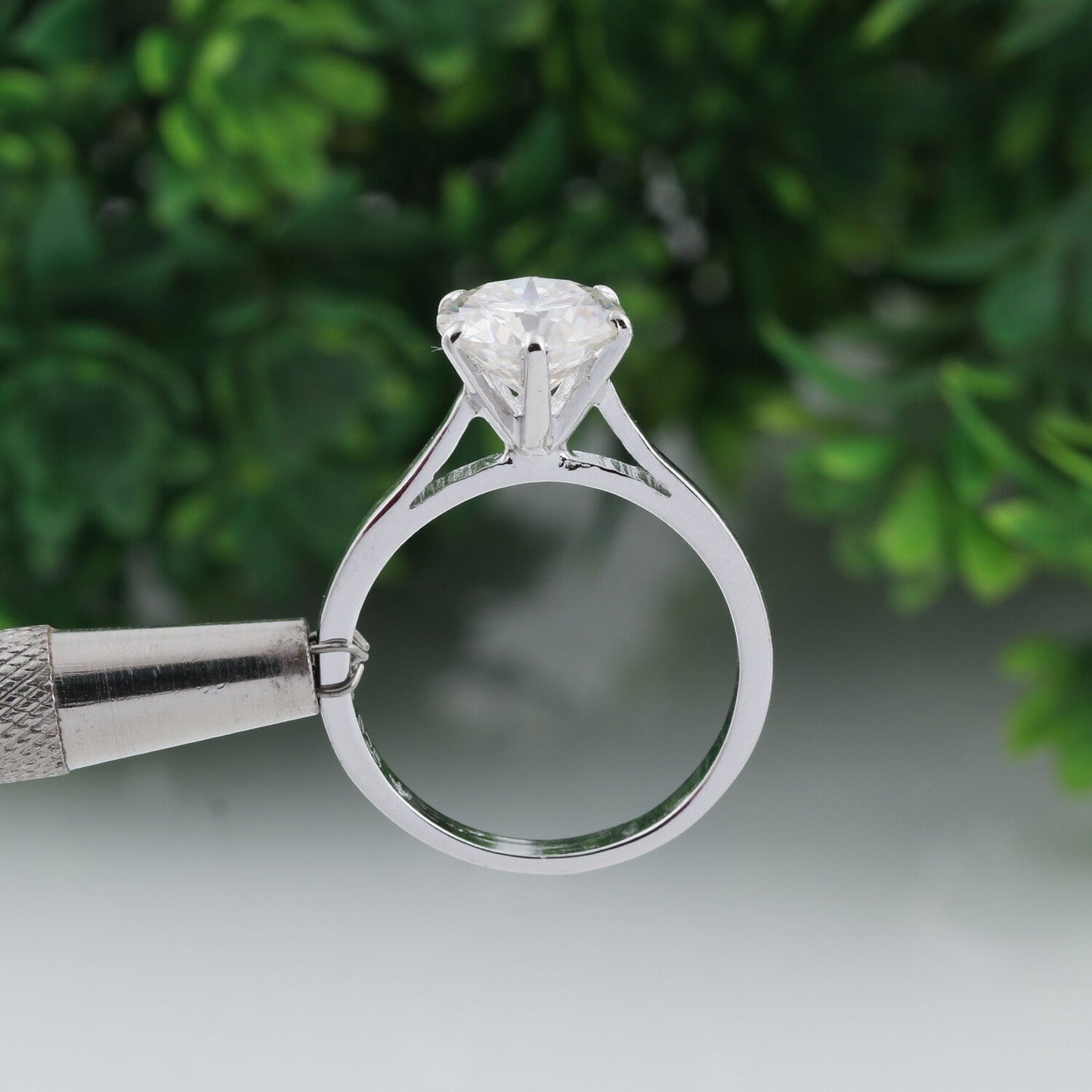 Side angle of round diamond solitaire showing cathedral gold vermeil shoulders