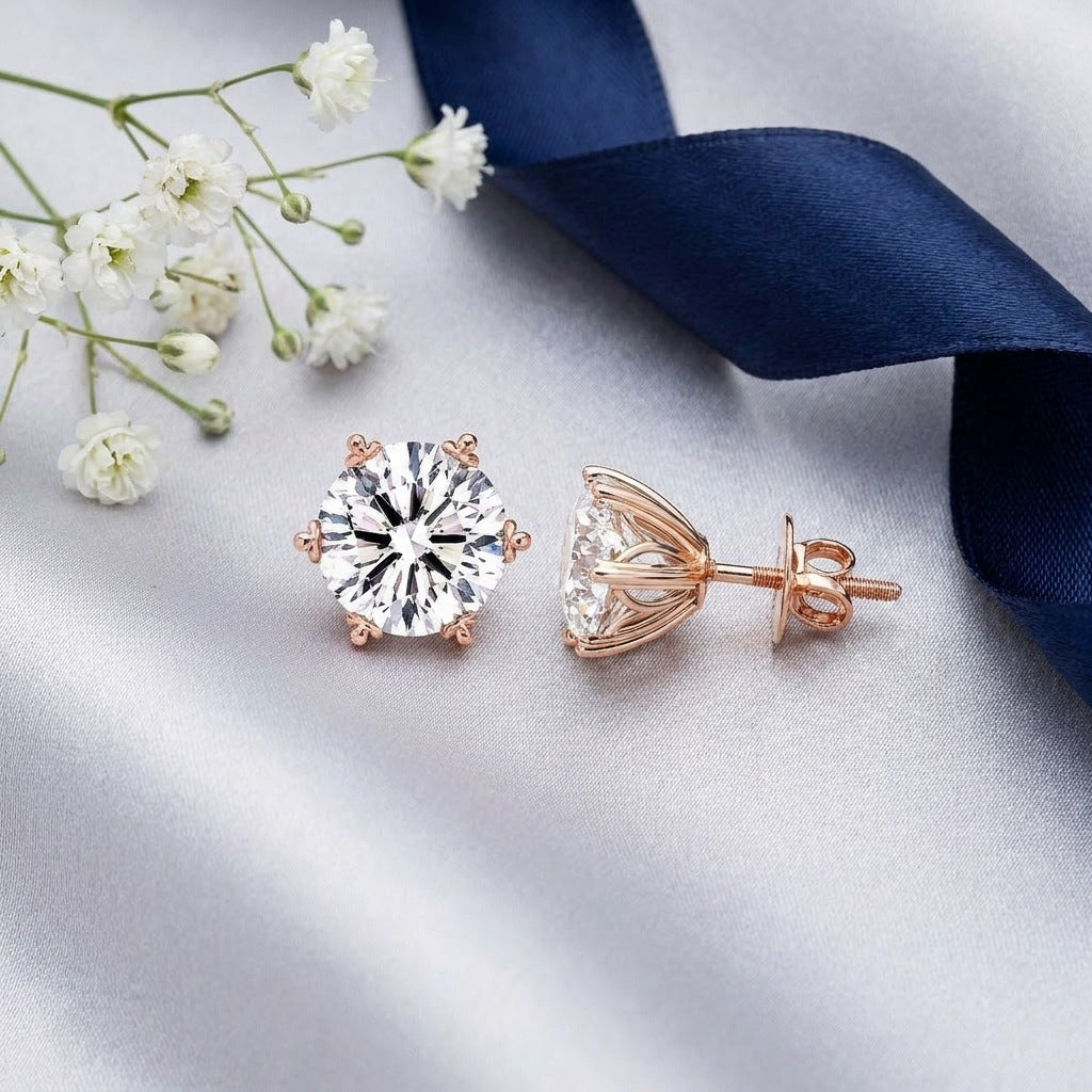Diamond solitaire studs flat-lay with silk and pearls