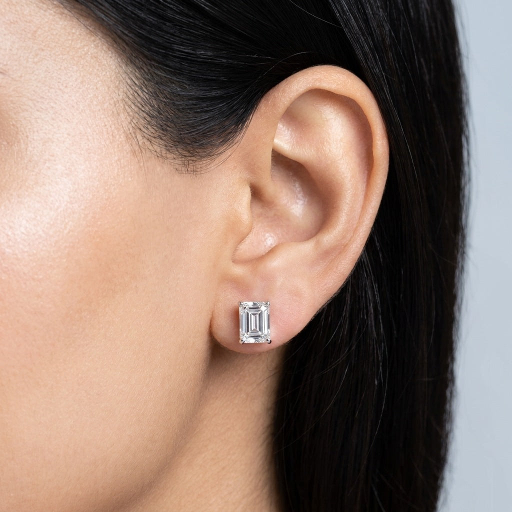 Close-up of emerald-cut diamond stud on the earlobe