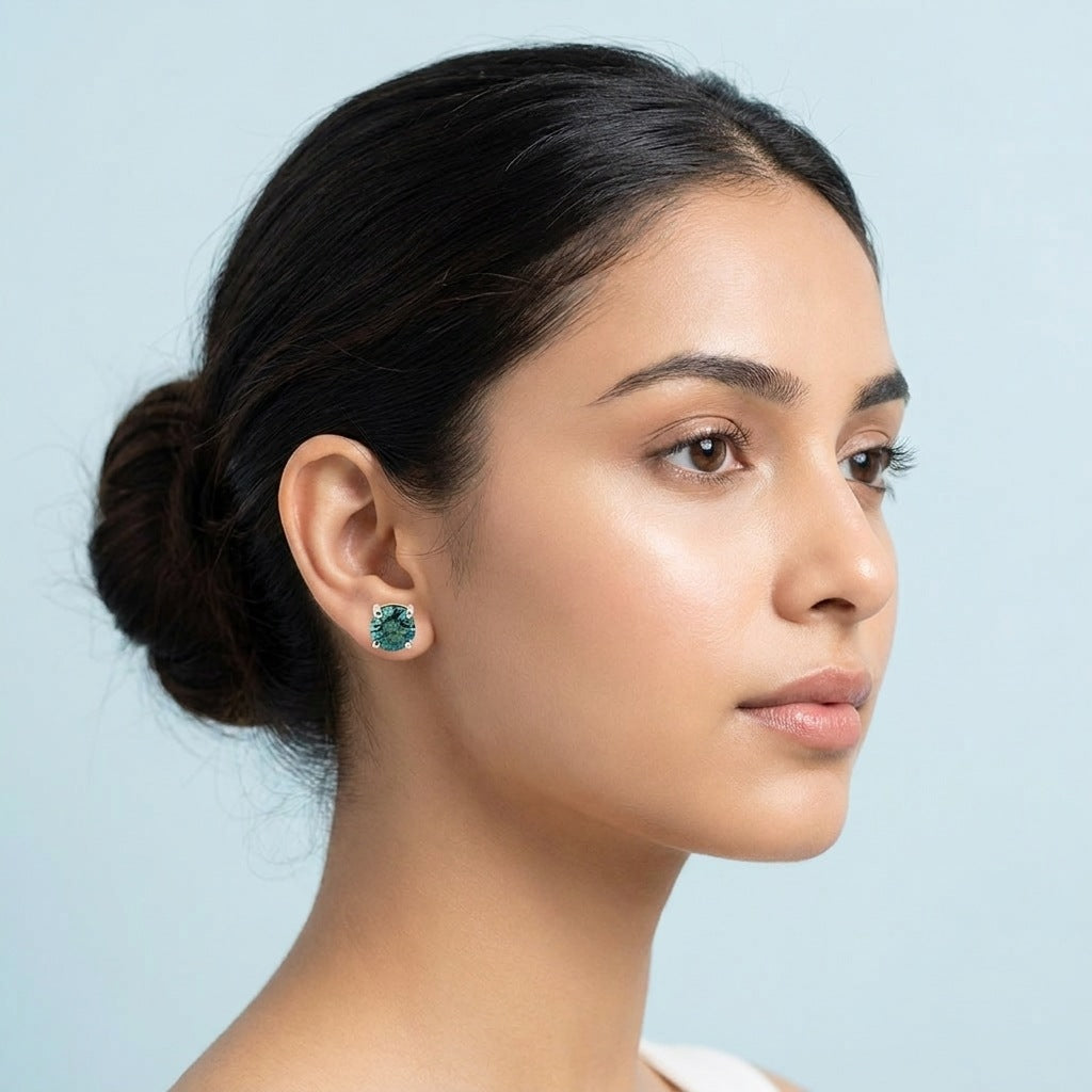 Teal blue moissanite stud worn on the ear
