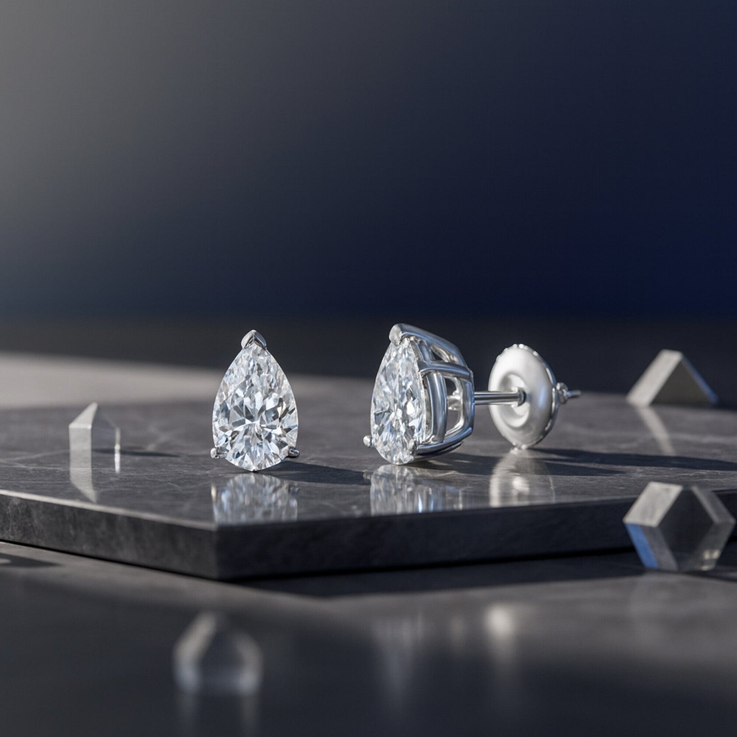 GEMHUB Pear-shaped lab-created diamond stud earrings in 950 platinum with screw backs. IGI certified.