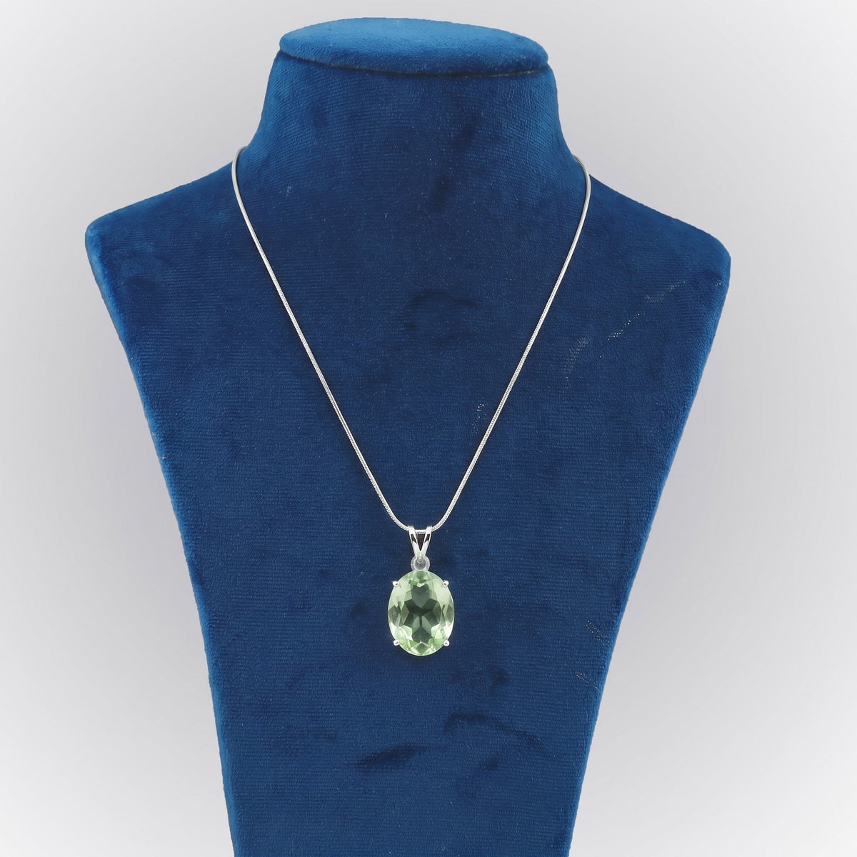 GEMHUB Green Amethyst Oval 135.5 Ct lab-grown gemstone pendant on display bust (AI render)