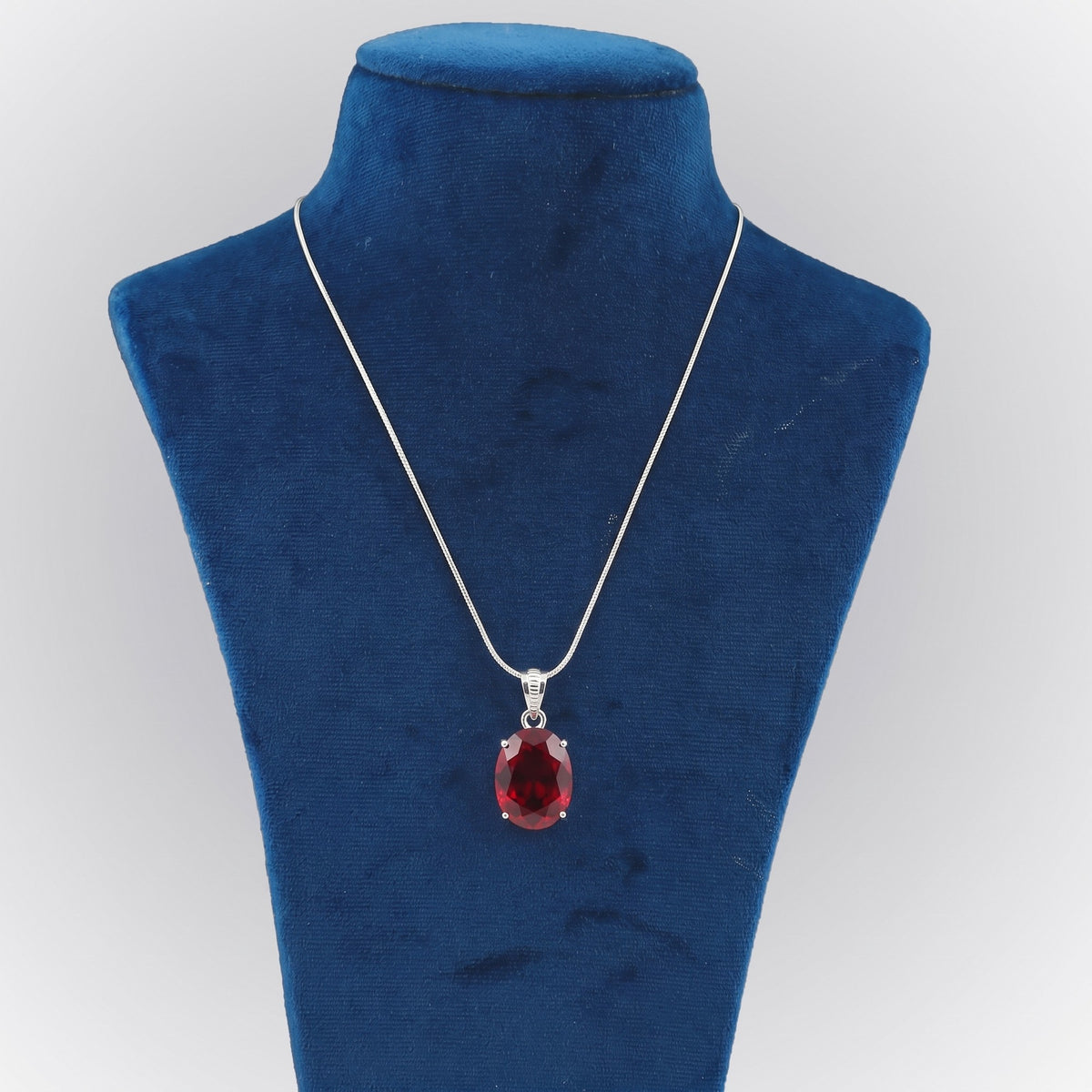 GEMHUB Red Topaz Oval 90 Ct lab-grown gemstone pendant on display bust (AI render)
