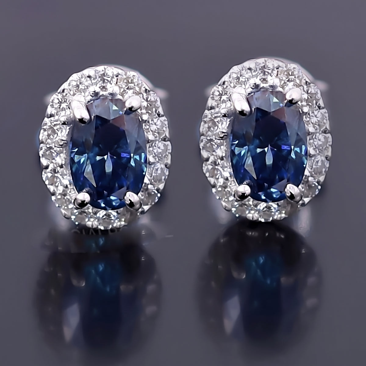 2.00ct blue moissanite halo studs - detail view showing oval centre stone and pave surround