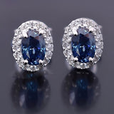 2.00ct blue moissanite halo studs - detail view showing oval centre stone and pave surround