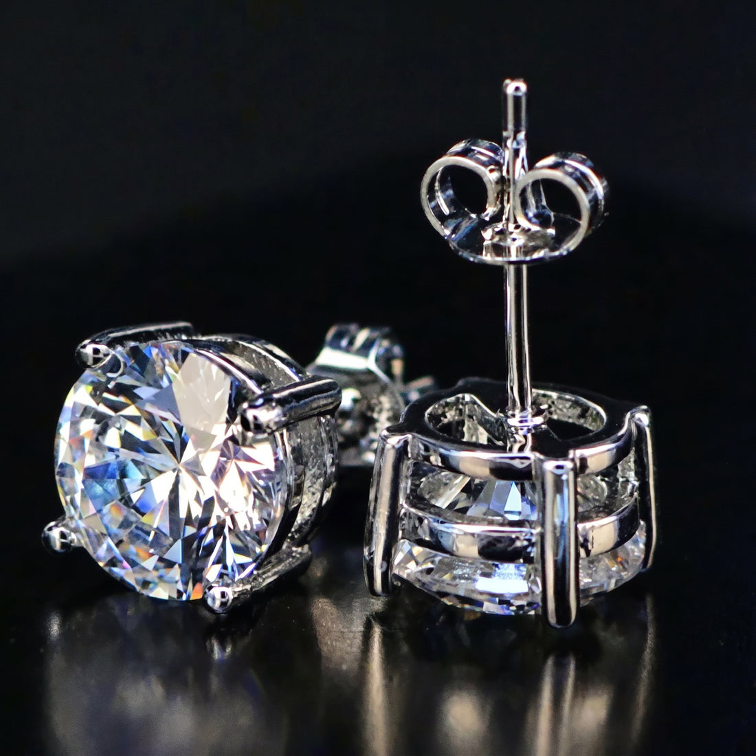 4.20ct white moissanite round studs - front and side view showing four-prong setting