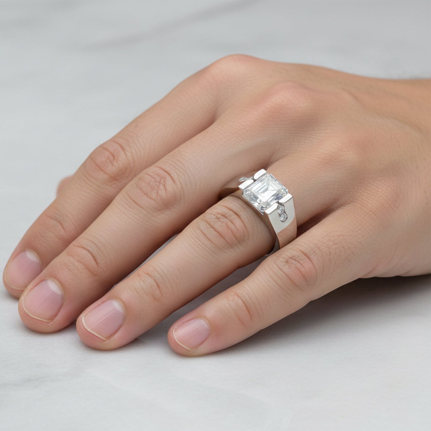Side angle of 2 carat emerald diamond ring with gold vermeil four-prong setting