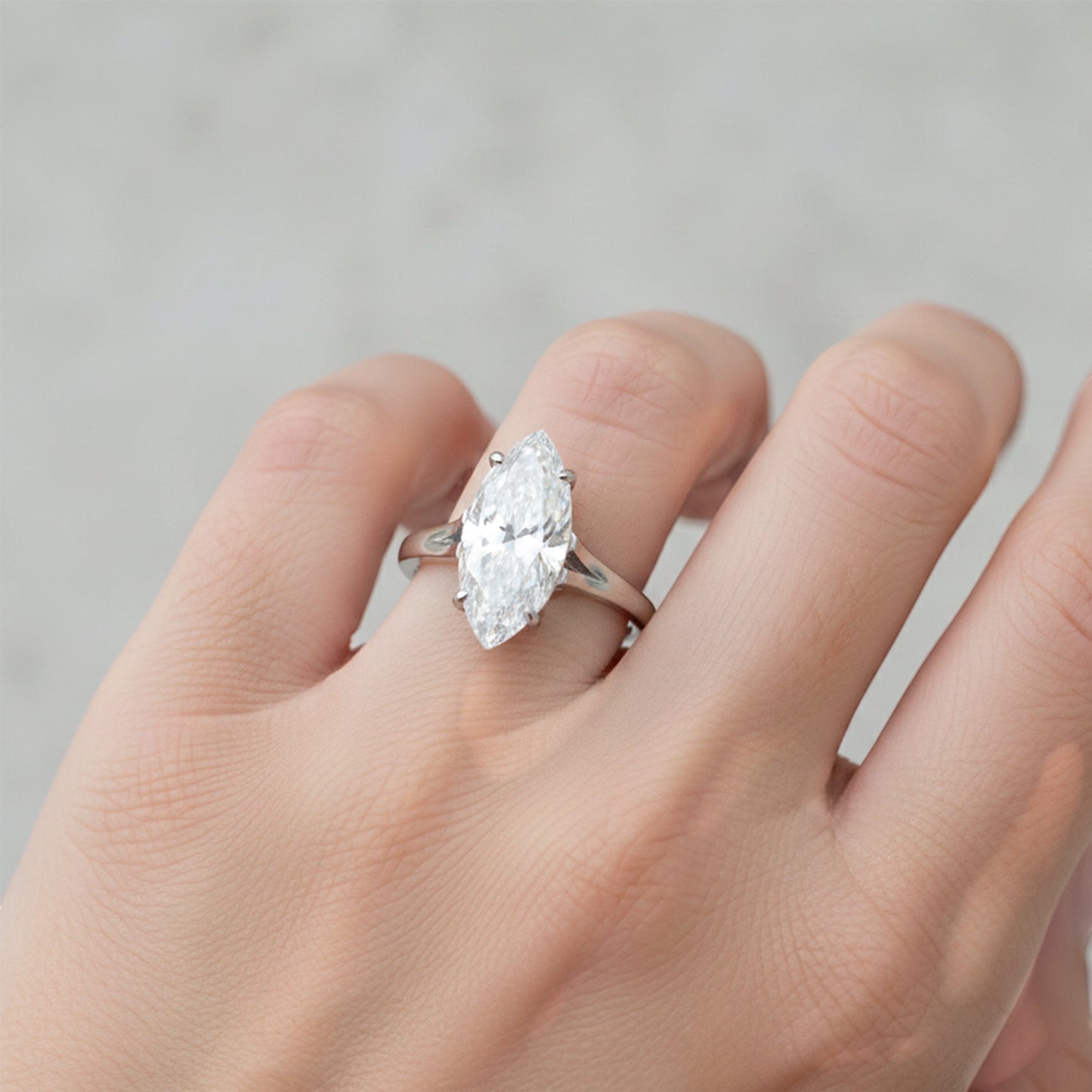 Side angle of marquise diamond ring with gold vermeil six-prong setting detail