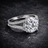 Round lab diamond solitaire with pavé shoulders on dark background, full fire