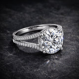 Round lab diamond solitaire with pavé shoulders on dark background, full fire