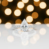 Detail of 18k gold vermeil prong holding tip of pear-cut diamond