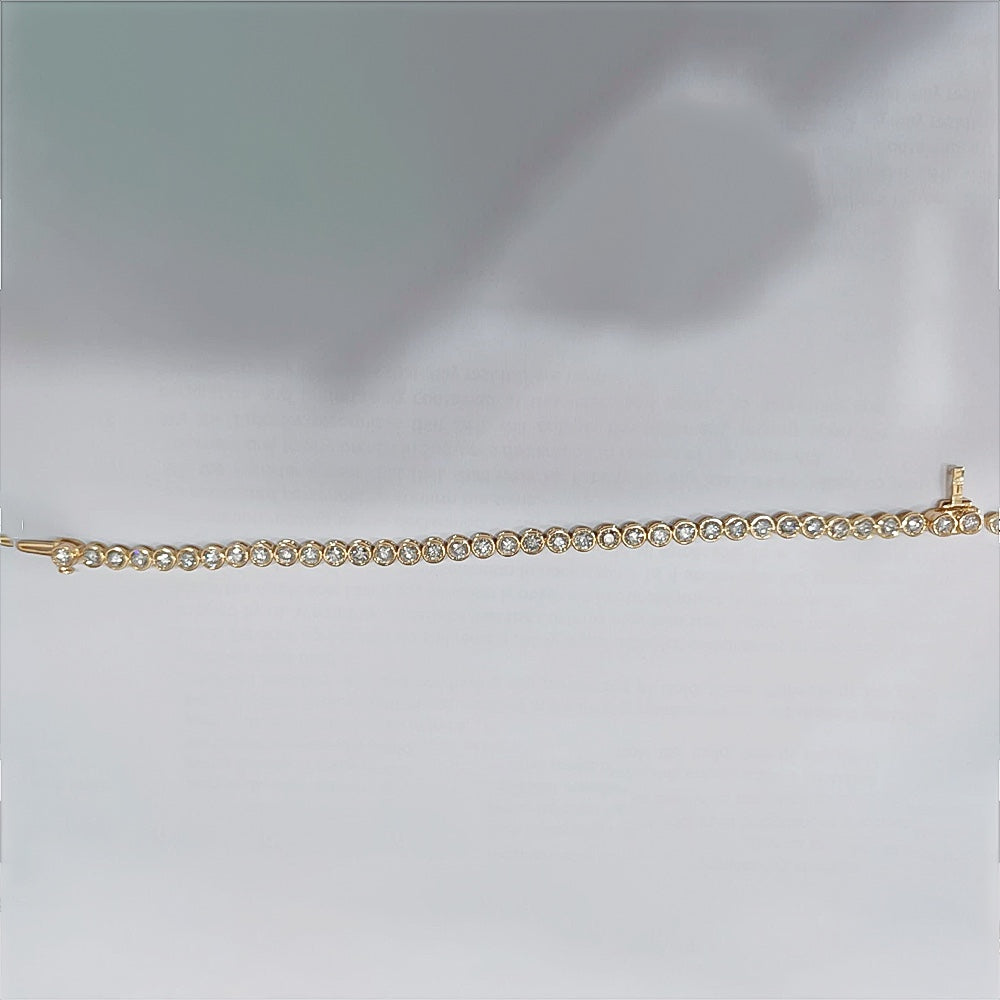 Underside of bezel tennis bracelet showing 14k yellow gold hallmark
