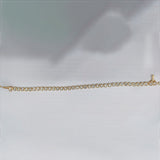 Underside of bezel tennis bracelet showing 14k yellow gold hallmark