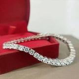 Detail of prong-set round diamond on natural diamond tennis bracelet