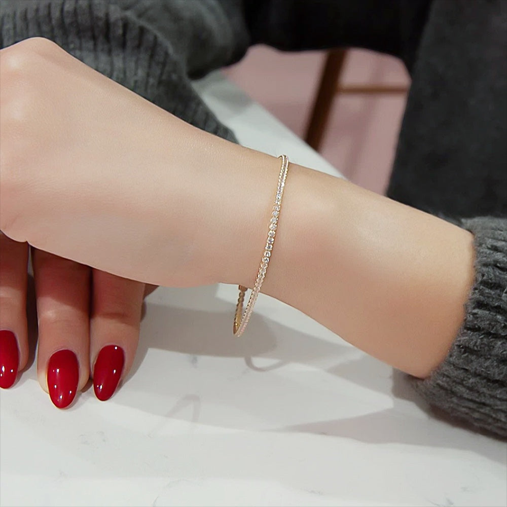 Diamond tennis bracelet worn on wrist, daily-wear refined gold jewellery
