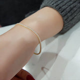 Close-up of natural diamond link showing prong setting and round cut