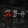 Side view of garnet dangle earrings with sterling silver bezel and post
