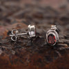 Close-up of oval-cut natural red garnet, gemmological clarity grade