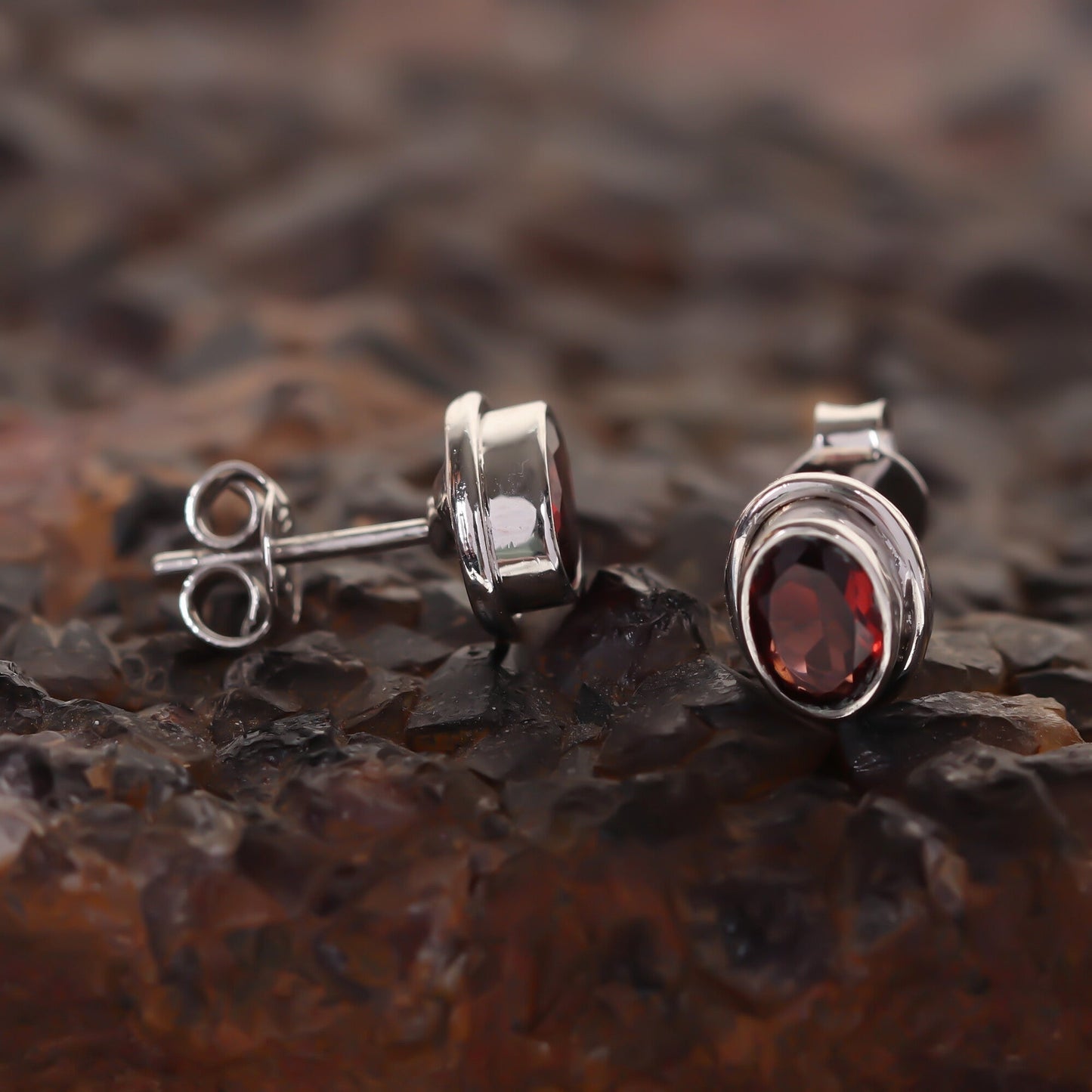 Close-up of oval-cut natural red garnet, gemmological clarity grade