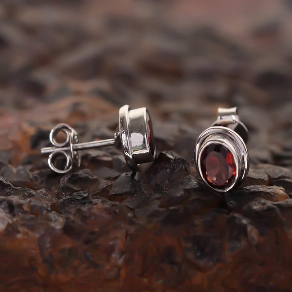 Close-up of oval-cut natural red garnet, gemmological clarity grade