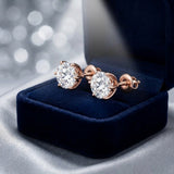 Pair of diamond solitaire studs in a navy velvet gift box