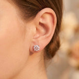 Close-up of round pale pink moissanite stud on earlobe