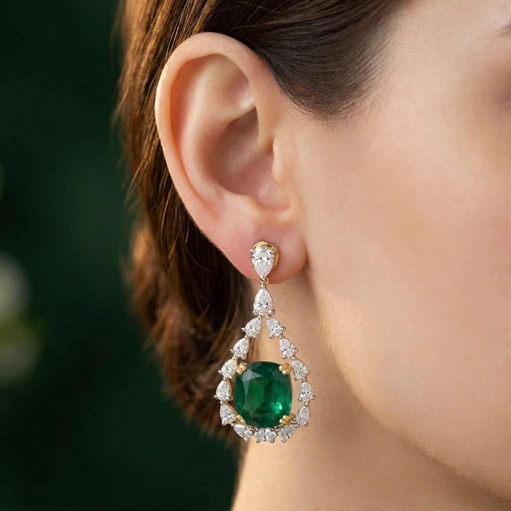 Close-up of green emerald drop earring on the earlobe