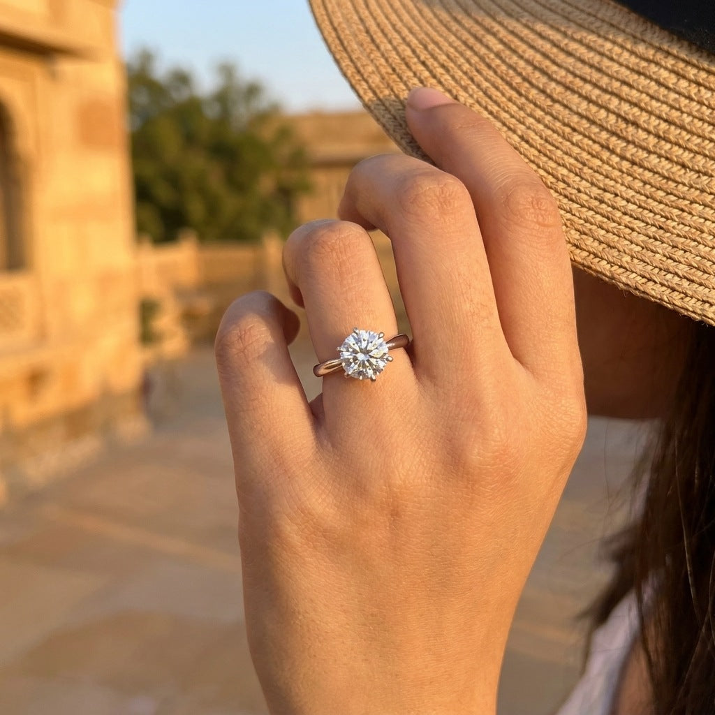 Round moissanite solitaire ring lifestyle photo at golden hour