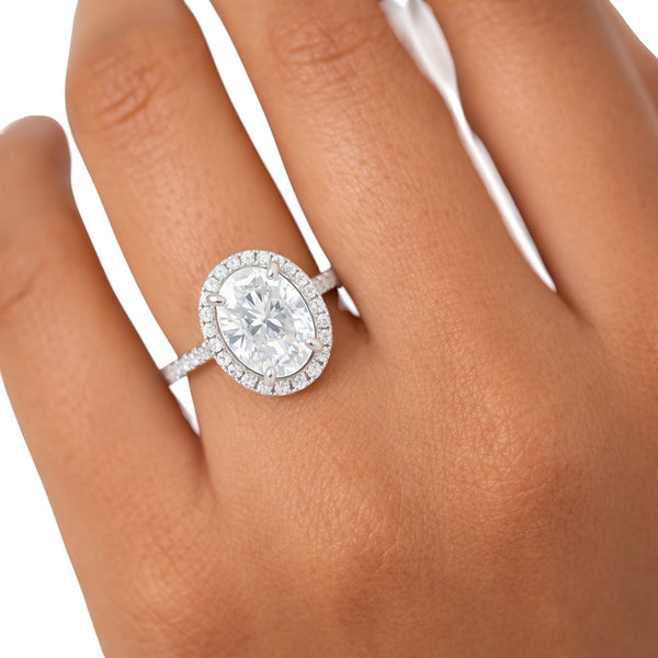 GEMHUB 3.00 Ct oval cut lab grown diamond ring with VS1 clarity, set in 18k gold vermeil with a halo of smaller diamonds.