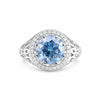 GEMHUB 3.50 Ct round cut blue lab grown diamond ring with VS1 clarity, set in 18k gold vermeil with a halo of small white diamonds.