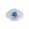 GEMHUB 3.50 Ct round cut blue lab grown diamond ring with VS1 clarity, set in 18k gold vermeil with a halo of small white diamonds.