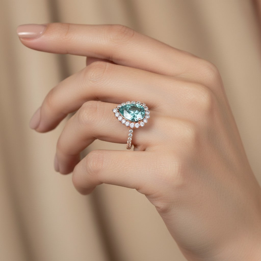 GEMHUB 4.70 Ct blue pear cut moissanite solitaire ring with diamond halo and band, set in gold vermeil.