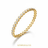 Side angle of 14k yellow gold bezel diamond bracelet with clasp visible