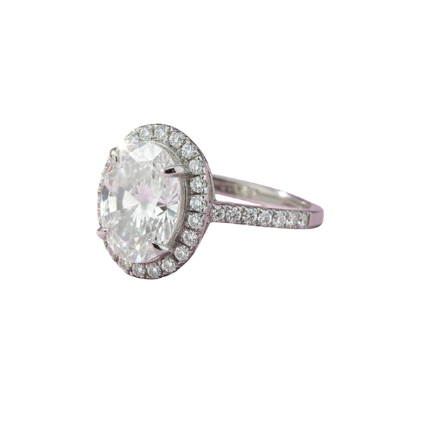GEMHUB 3.00 Ct oval cut lab grown diamond ring with VS1 clarity, set in 18k gold vermeil with a halo of smaller diamonds.