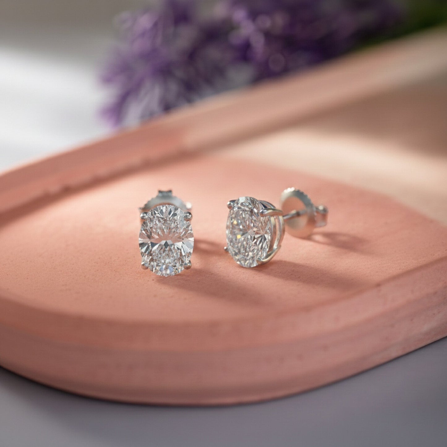 GEMHUB pair of oval lab-created diamond stud earrings in 950 platinum with screw backs.