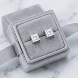 Pair of princess cut diamond studs in a grey velvet gift box