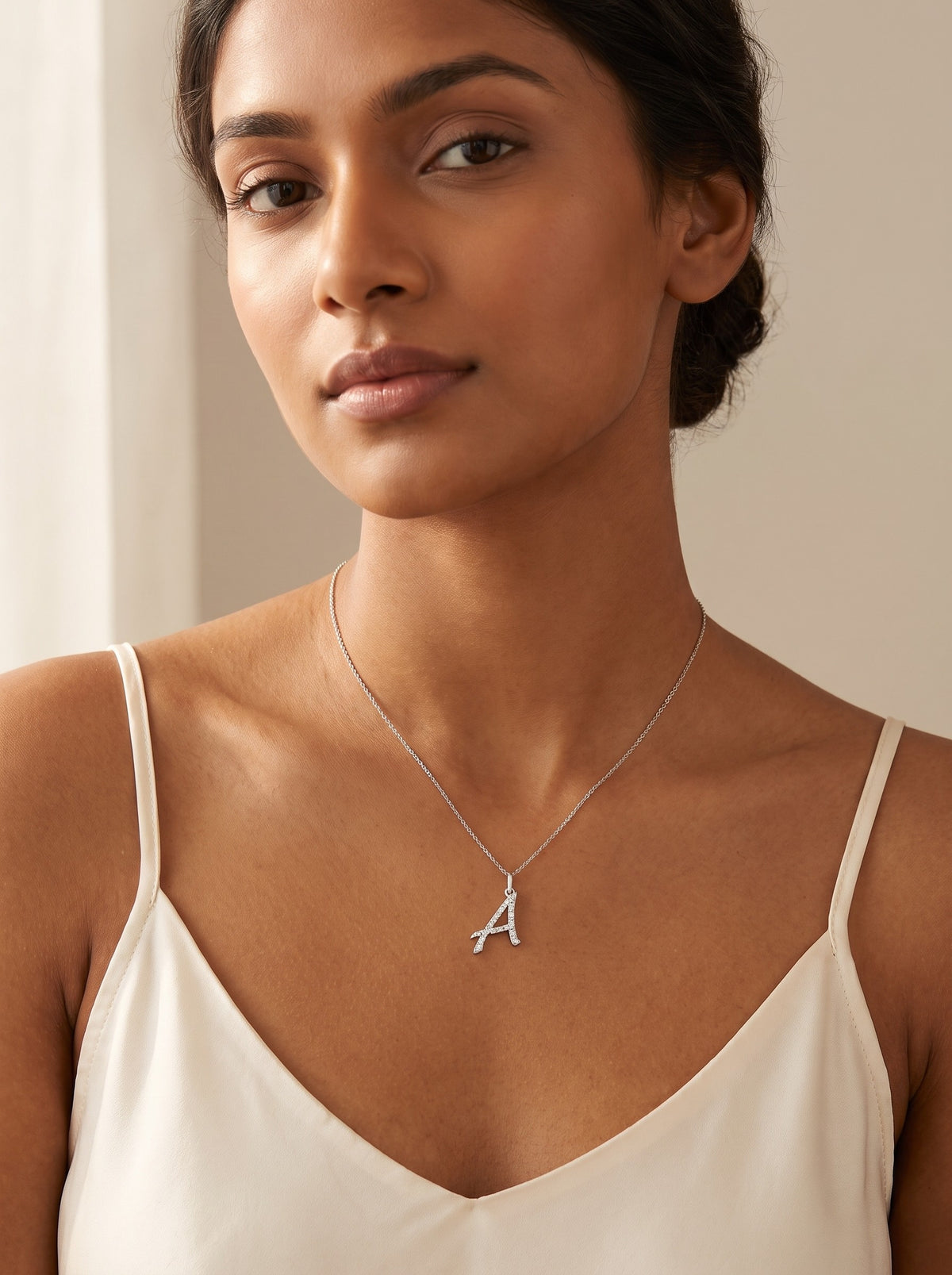 GEMHUB model wearing the diamond initial pendant on a fine chain