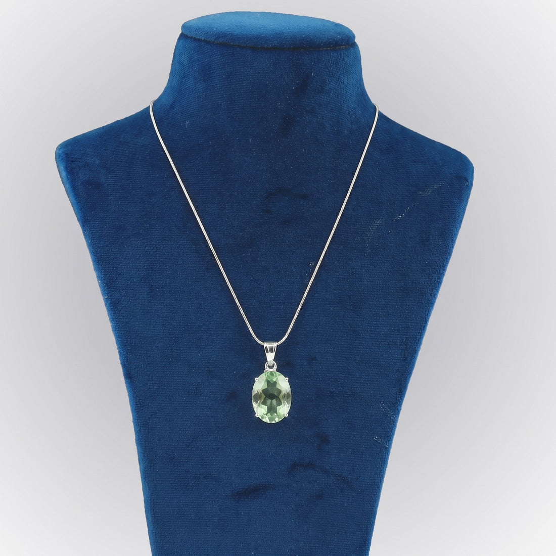 GEMHUB Green Amethyst Oval 105 Ct lab-grown gemstone pendant on display bust (AI render)