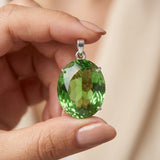 GEMHUB Green Amethyst Oval 100 Ct pendant held in hand for size (AI)