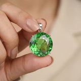 GEMHUB Green Amethyst Round 133.4 Ct pendant held in hand for size (AI)