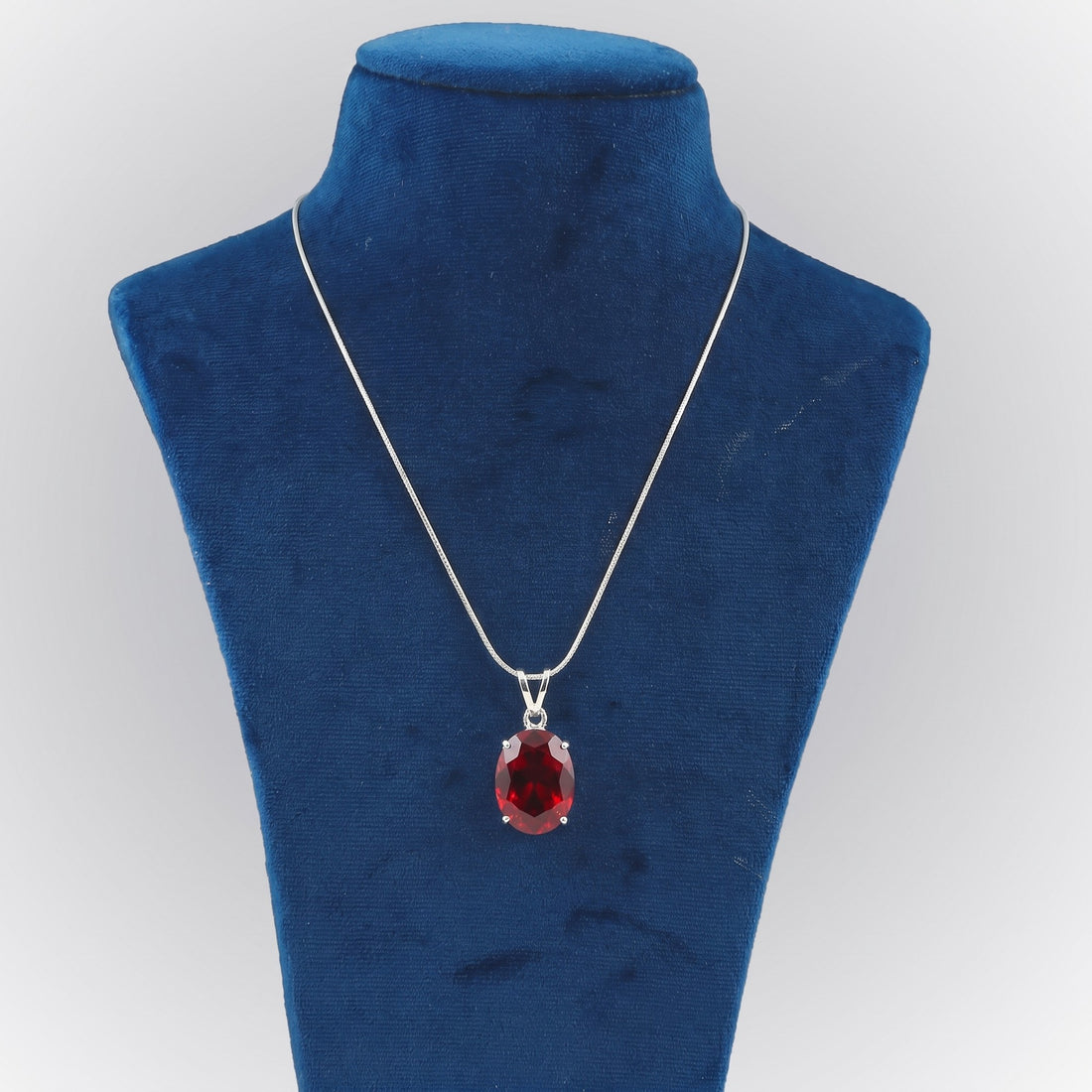 GEMHUB Red Topaz Oval 105 Ct lab-grown gemstone pendant on display bust (AI render)