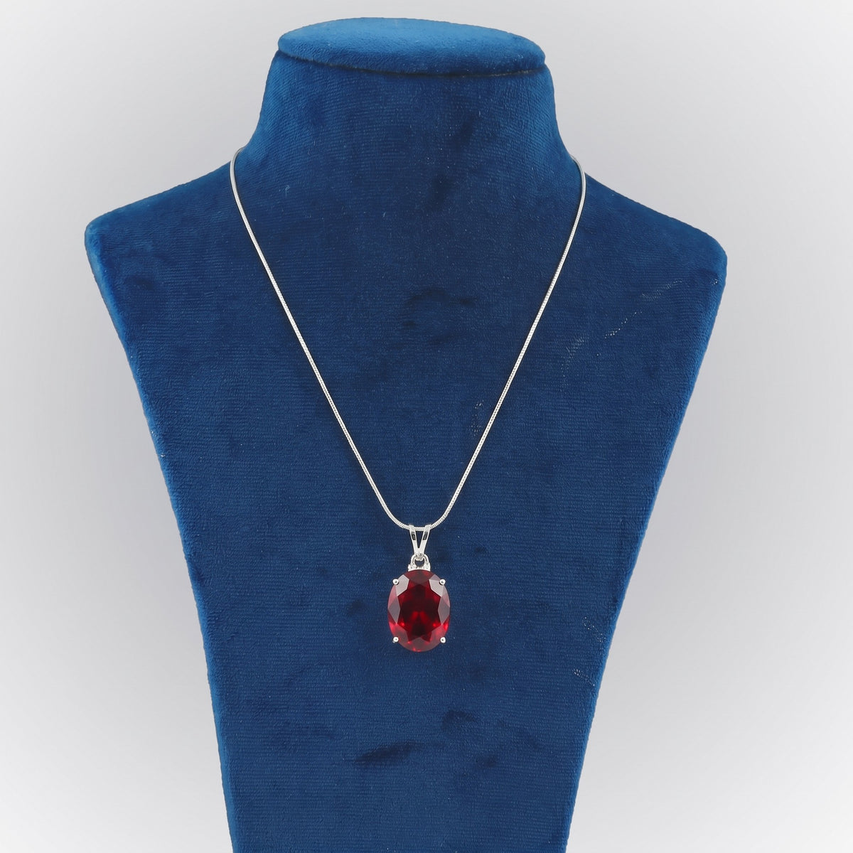 GEMHUB Red Topaz Oval 85 Ct lab-grown gemstone pendant on display bust (AI render)