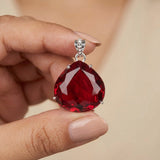 GEMHUB Red Topaz Pear 90 Ct pendant held in hand for size (AI)