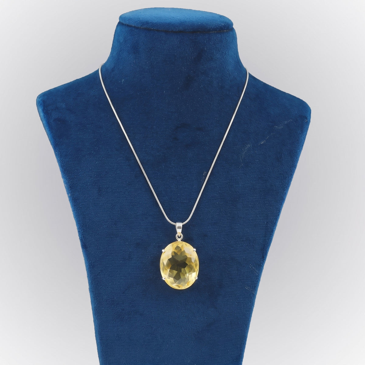GEMHUB Yellow Citrine Oval 120 Ct lab-grown gemstone pendant on display bust (AI render)